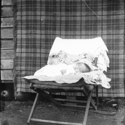 Baby asleep on a chair