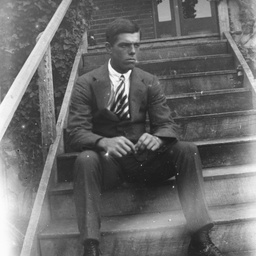 Young man sitting on some steps