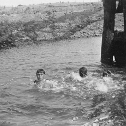 Boys swimming in river