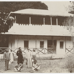 Group outside two storey house