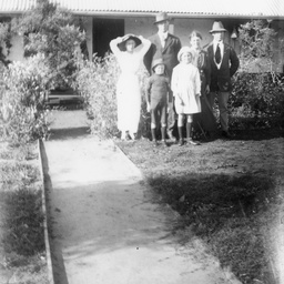 Family group in front of a cottage