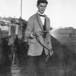 A man using a watering hose