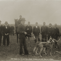 Group of men with greyhounds