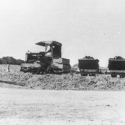 Jervois Embankment 1929 with tractor train hauling small trucks