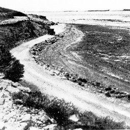 Car travelling up the road skirting the Coorong