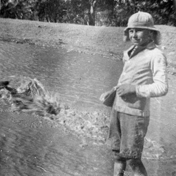 Boy standing in a creek