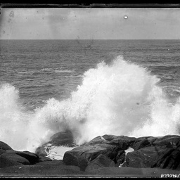 Wave crashing over rocks.