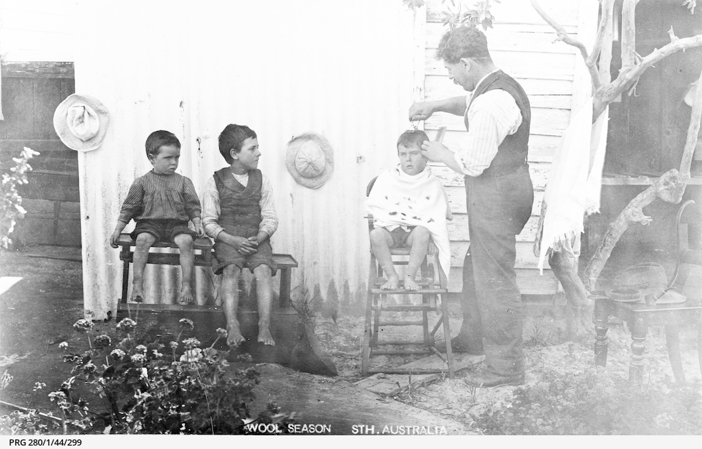 A father cutting his son's hair • Photograph • State ...