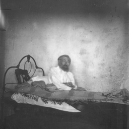 Man sitting up in bed
