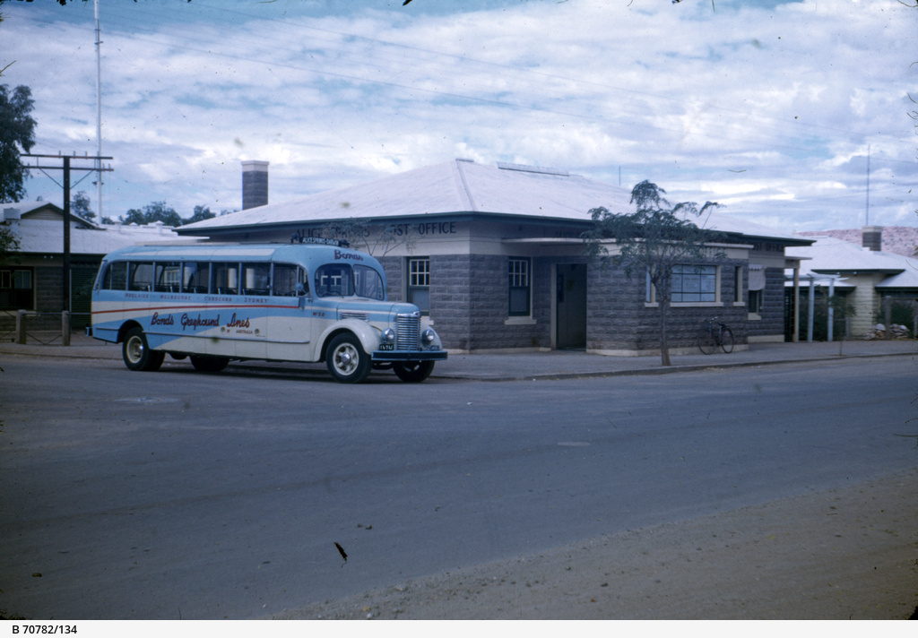 Alice Springs Post Office and a Bond's bus • Photograph • State Library