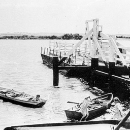 Children playing in small rowboats beside the Tailem Bend ferry