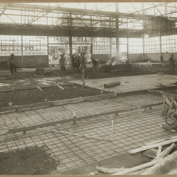 Workers laying concrete floor in Body Mill.
