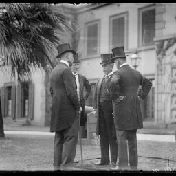 A group of four men at Government House