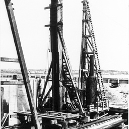Goolwa barrage construction site with distant sandhills and shacks
