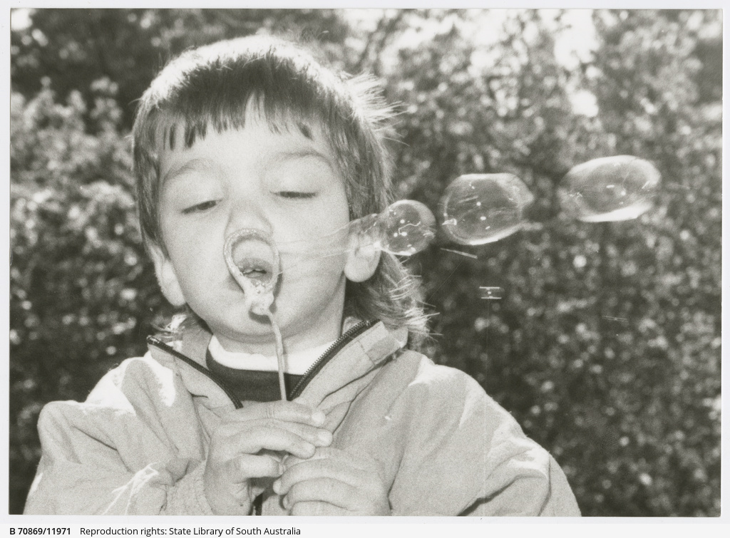 3 year old Emanuel blowing bubbles for peace at Lady Gowrie child care