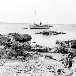 A small yacht off a rocky beach at Nine Mile Point on the Coorong