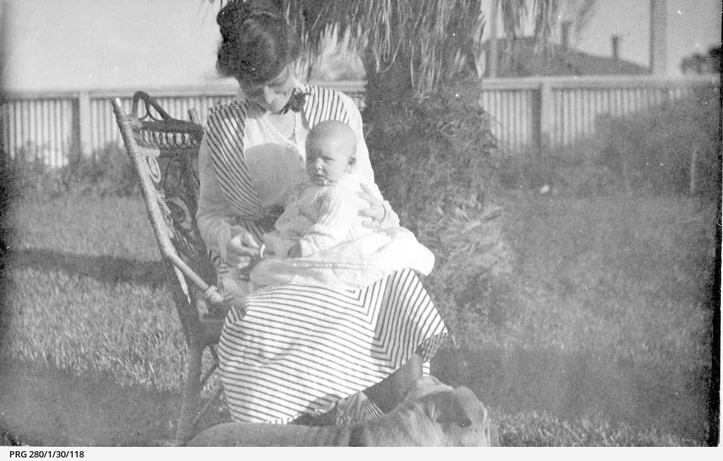 Mrs. Dorothy Chappell smiling at a baby