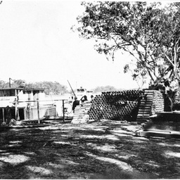 Paddle steamer W.F.B. unloading pipes at river bank