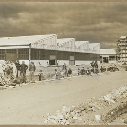 Workers laying high tension cable.