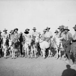 Men riding donkeys.